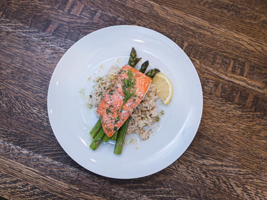 salmon on bed of asparagus and rice